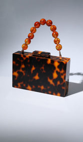 ACRYLIC BEADED CLUTCH IN AMBER